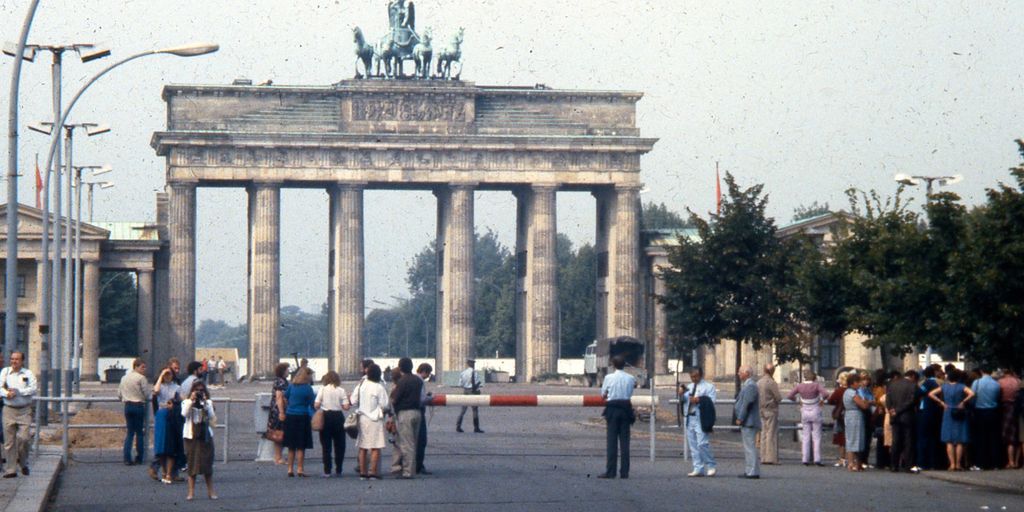 diverse group of people in Berlin with Brandenburg Gate in background