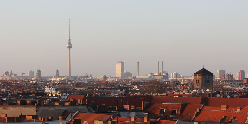 Berlin skyline with economic growth charts and symbols
